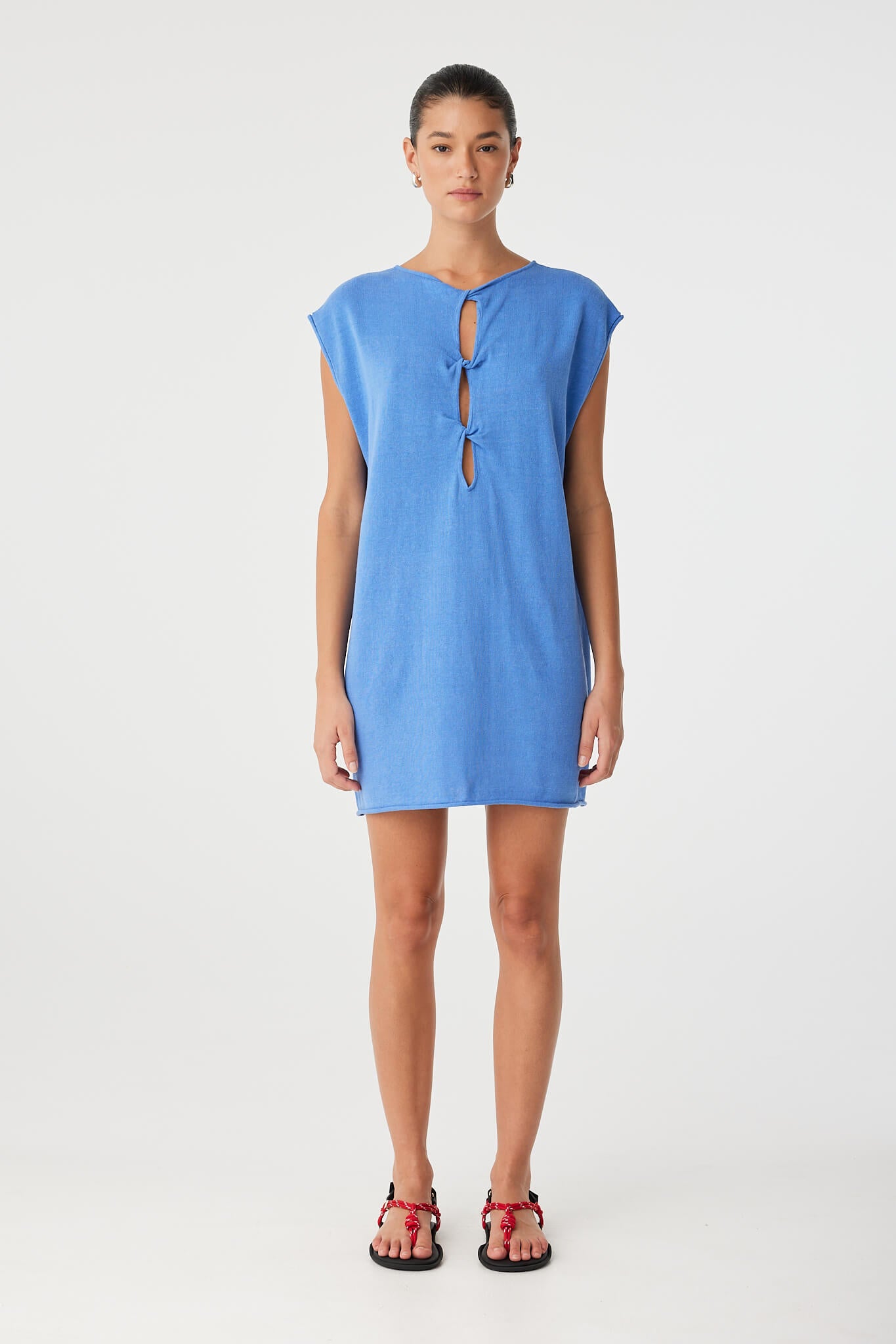 Pala mini dress styled with twist cut-out worn at front, adding sculptural detail to a relaxed straight-fit silhouette in soft natural fabric.