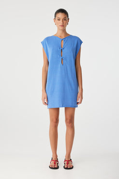 Pala mini dress styled with twist cut-out worn at front, adding sculptural detail to a relaxed straight-fit silhouette in soft natural fabric.