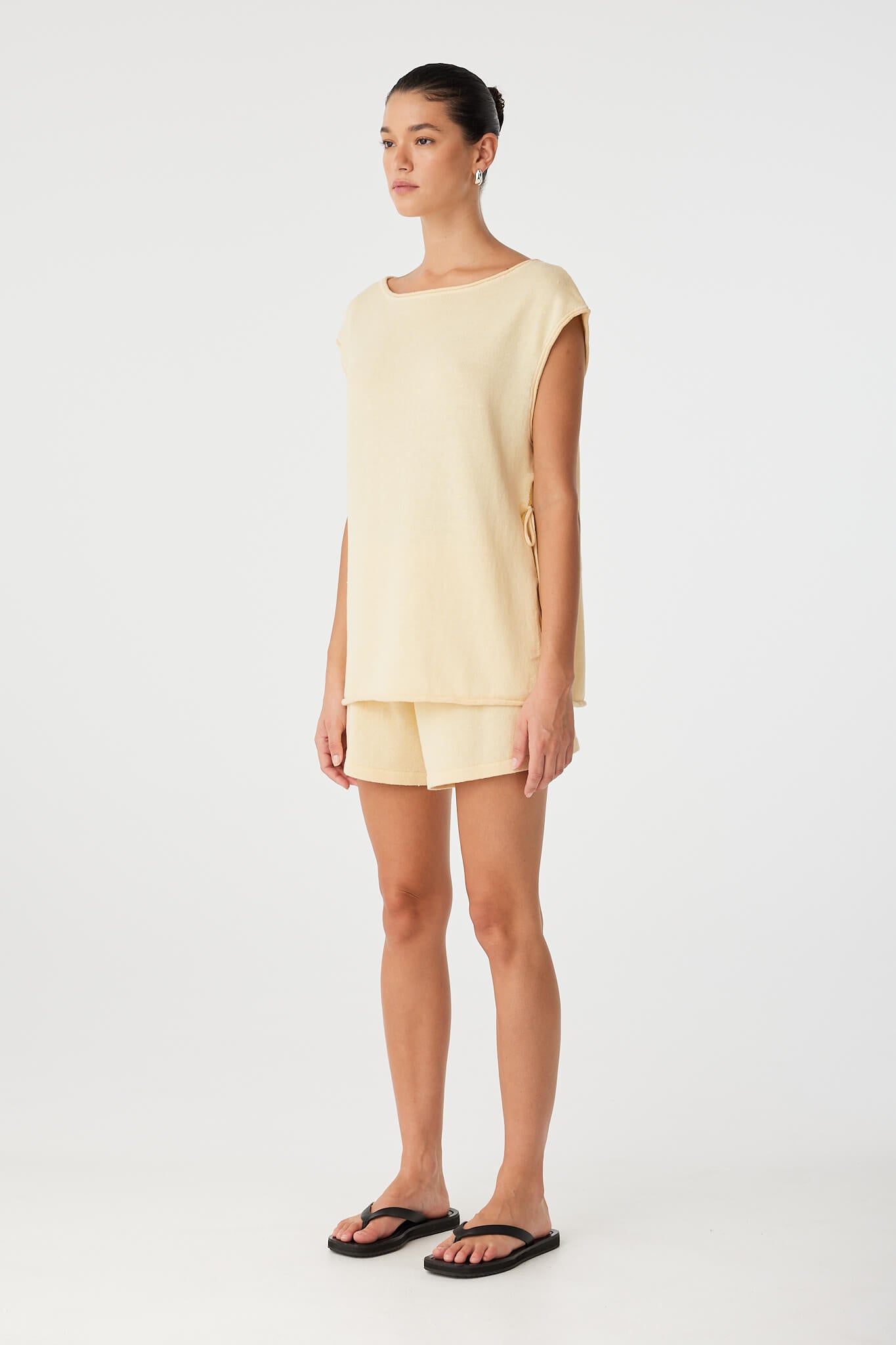 Relaxed styling of butter linen shorts with elastic waist and clean hemline.