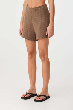 Side view of fitted ribbed waistband and slightly flared leg opening, designed for movement and breathable wear.
