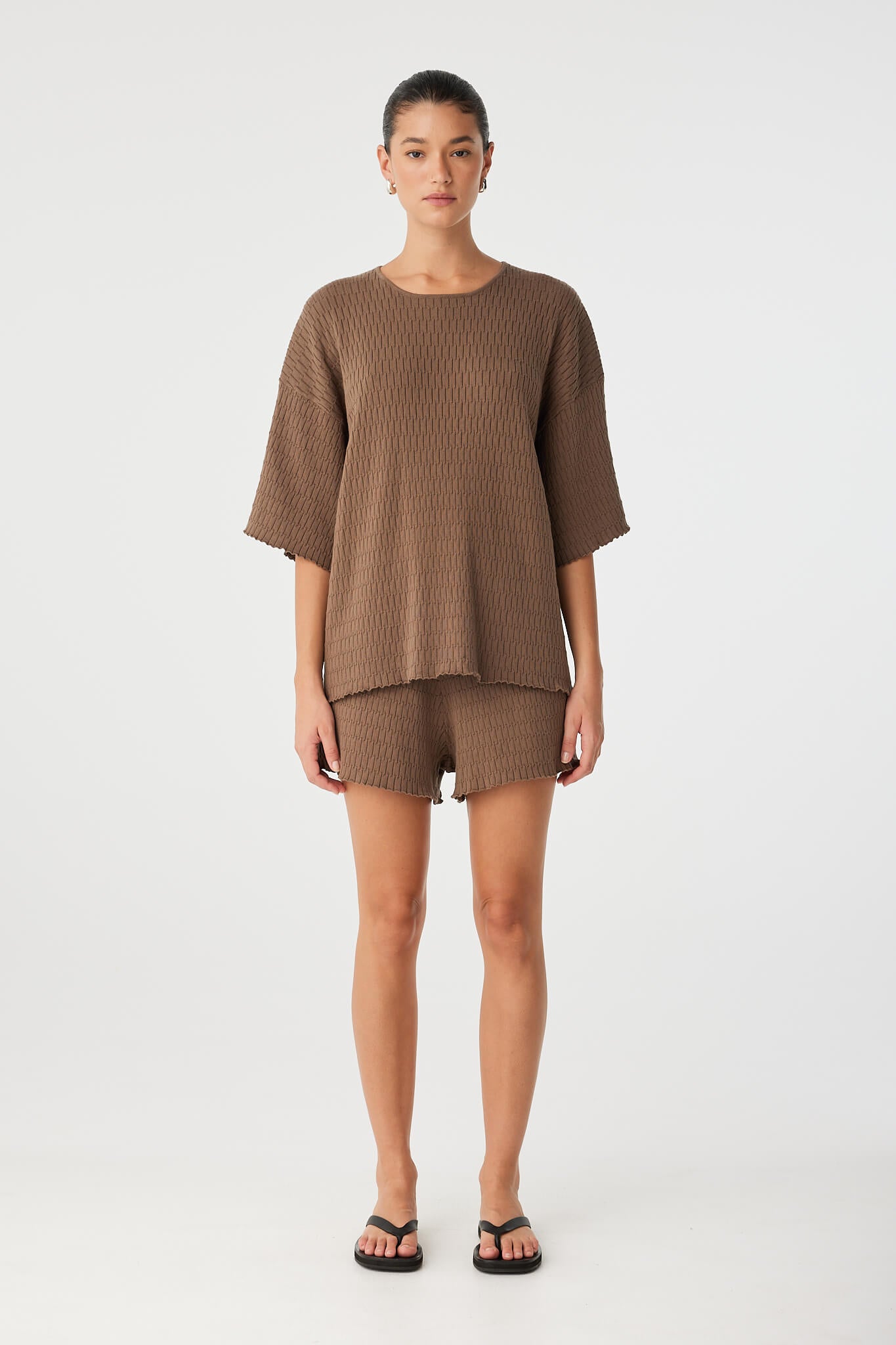 Full-length view of oversized knit tee in warm cacao, with relaxed sleeves and breathable organic texture.