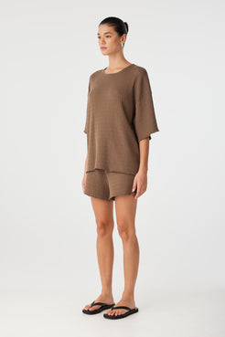 Side view of relaxed fit t-shirt in textured cacao knit, designed for movement and ease through warm days.