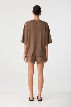 Back view of oversized organic cotton tee with dropped shoulder seam and straight hemline.