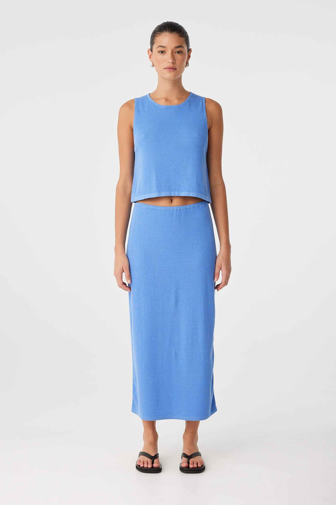 Relaxed-fit knit tank in blue cotton–hemp, showing rolled edges and clean lines—styled for summer ease.