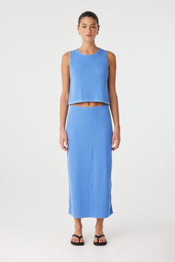 Relaxed-fit knit tank in blue cotton–hemp, showing rolled edges and clean lines—styled for summer ease.