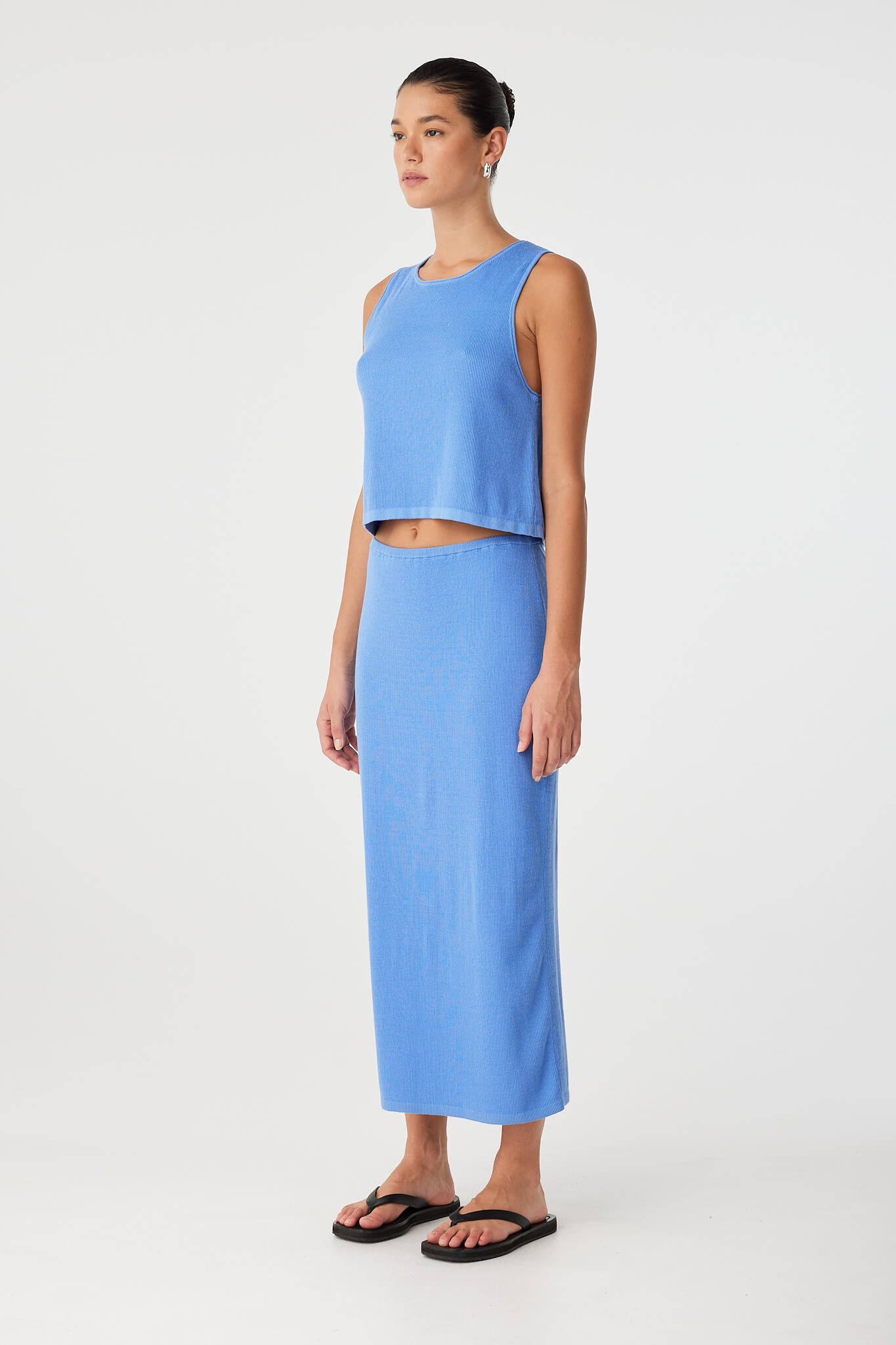 Side view of Theo Tank in lightweight knit with slight flare at hem and rolled armhole finish.