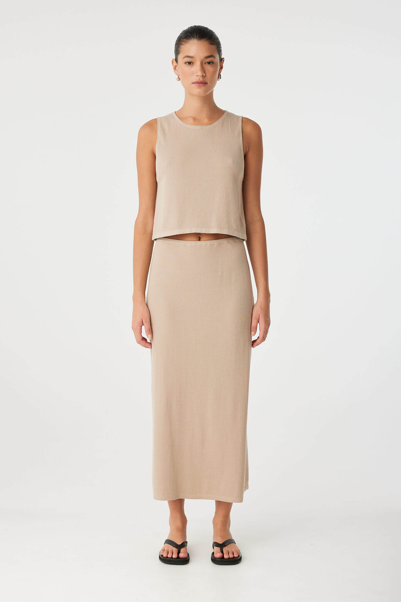 Sleeveless taupe tank styled with matching skirt in lightweight ribbed knit—ideal for elevated everyday dressing.