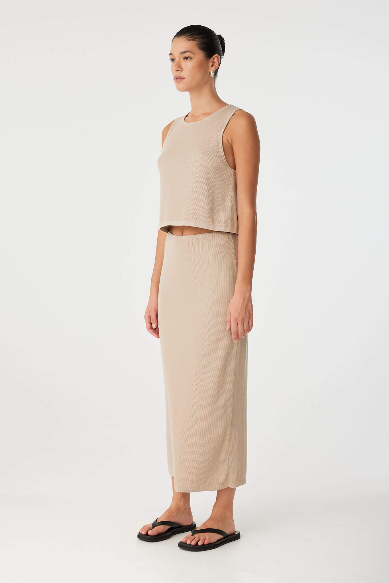 Side view of taupe knit tank showing relaxed armhole and clean finish, designed for warm-weather versatility.