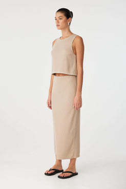 Side view of taupe knit tank showing relaxed armhole and clean finish, designed for warm-weather versatility.