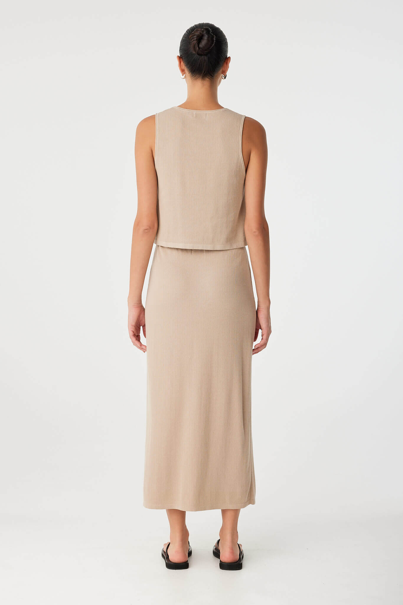 Back view of taupe ribbed tank with high neckline and soft flare—crafted from breathable natural fibres.