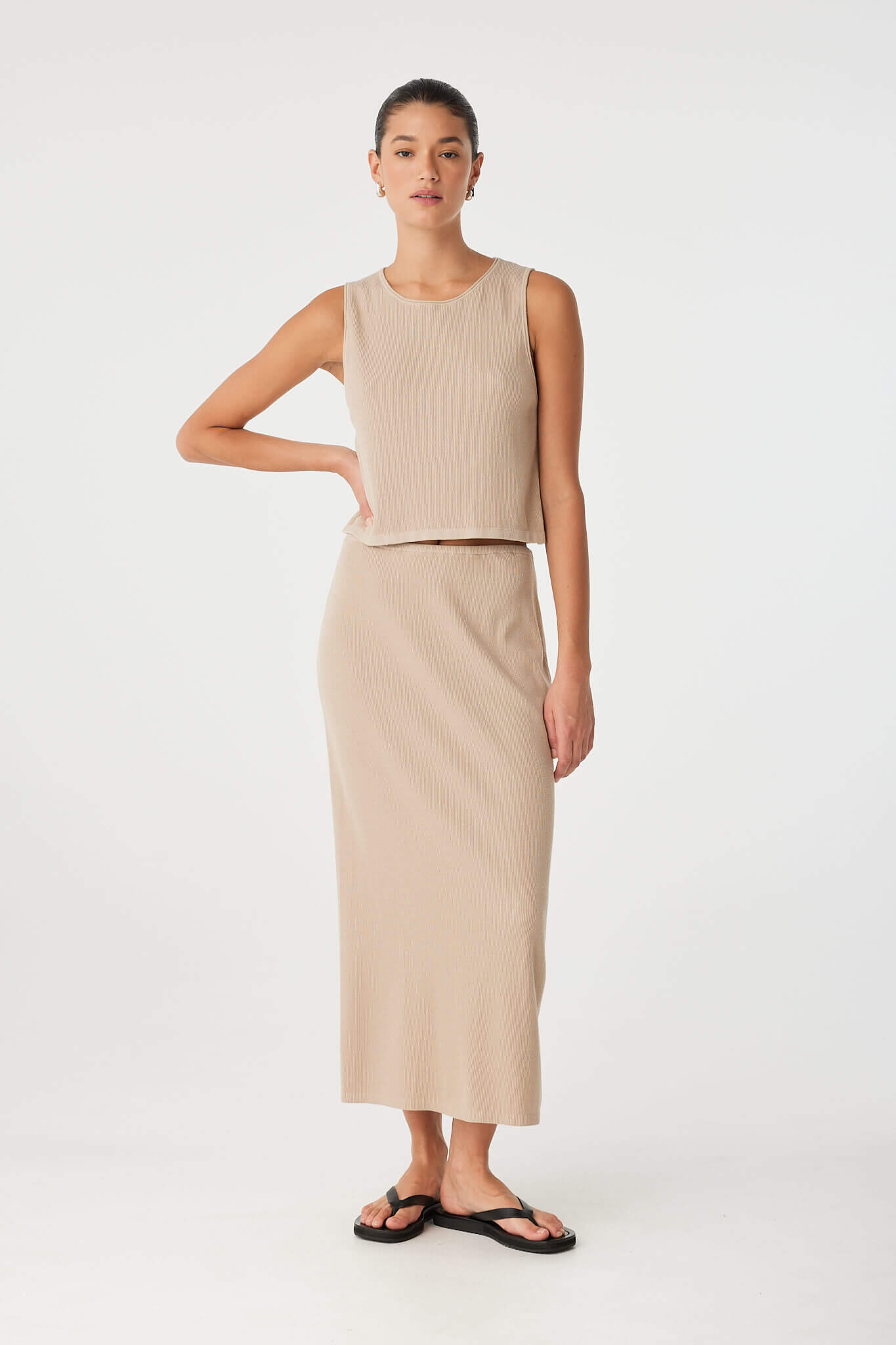 Neutral-toned knit tank with relaxed fit and rolled neckline, crafted for soft movement and breathable layering.