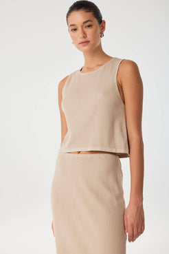 Model in taupe sleeveless tank and matching skirt, styled minimally for warm days and transitional layering.