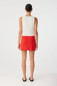 Full back view of red mini skirt with sporty finish, styled with sleeveless tank for warm-weather dressing.