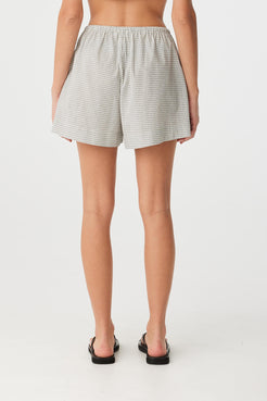 Back view of lightweight shorts in black check showing soft A-line fall and elastic waist fit.