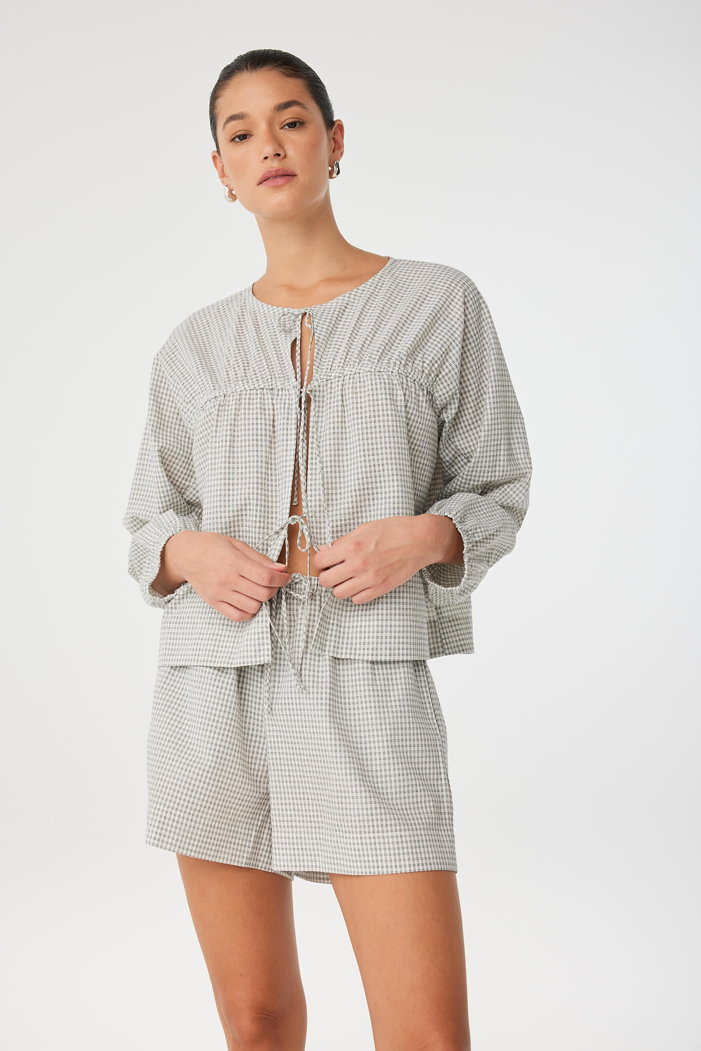 Close view of gathered neckline and tie-front detailing on soft cotton check blouse, crafted for everyday wear.