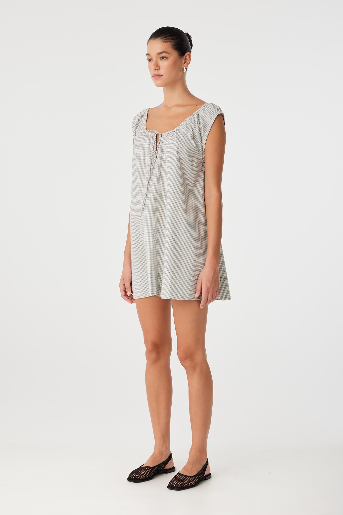 Cotton check dress in motion, showing drape and ease through the hem—perfect for layering or transitional climates.