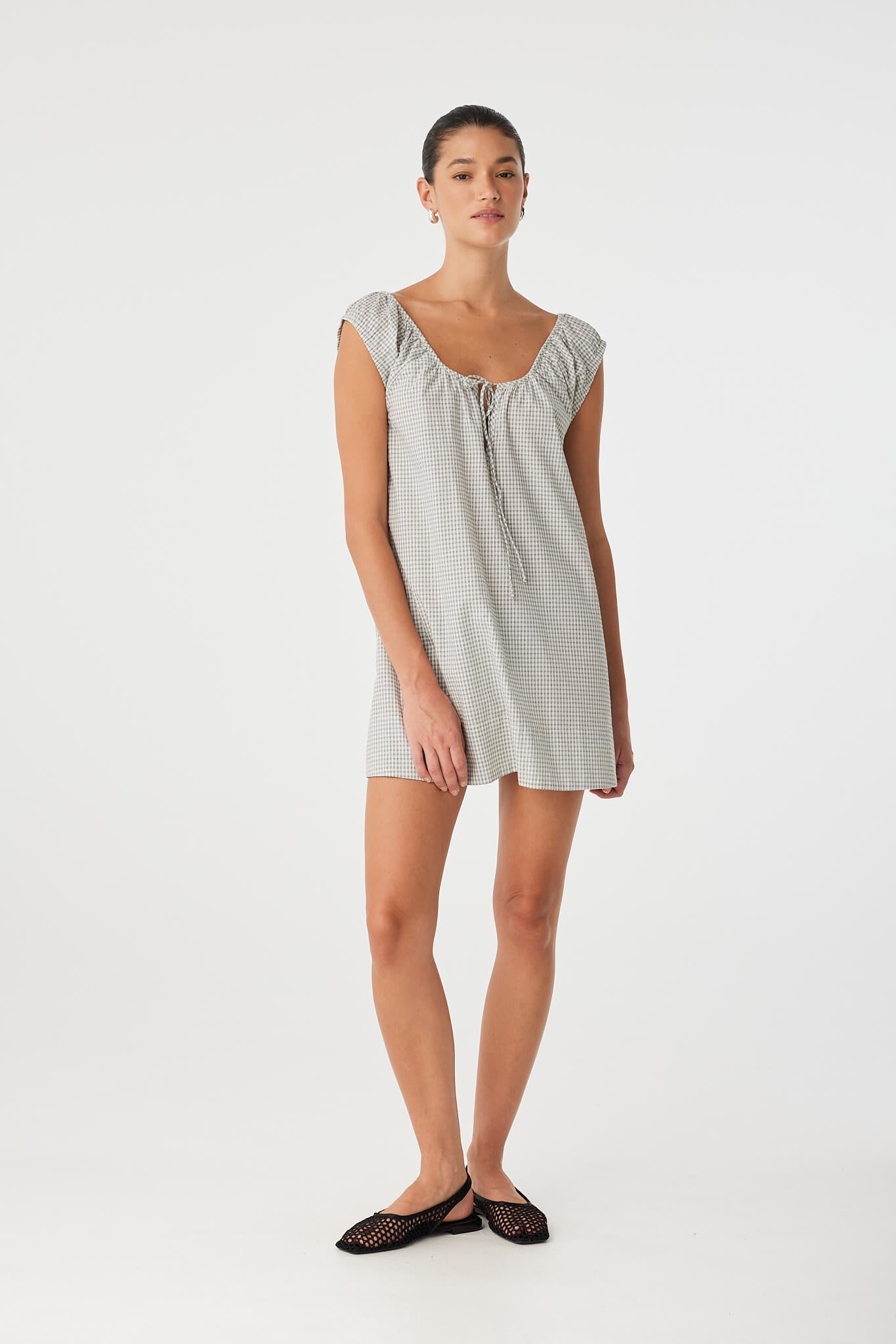 Straight-on view of airy black check mini dress with keyhole neckline, relaxed silhouette and natural cotton texture.