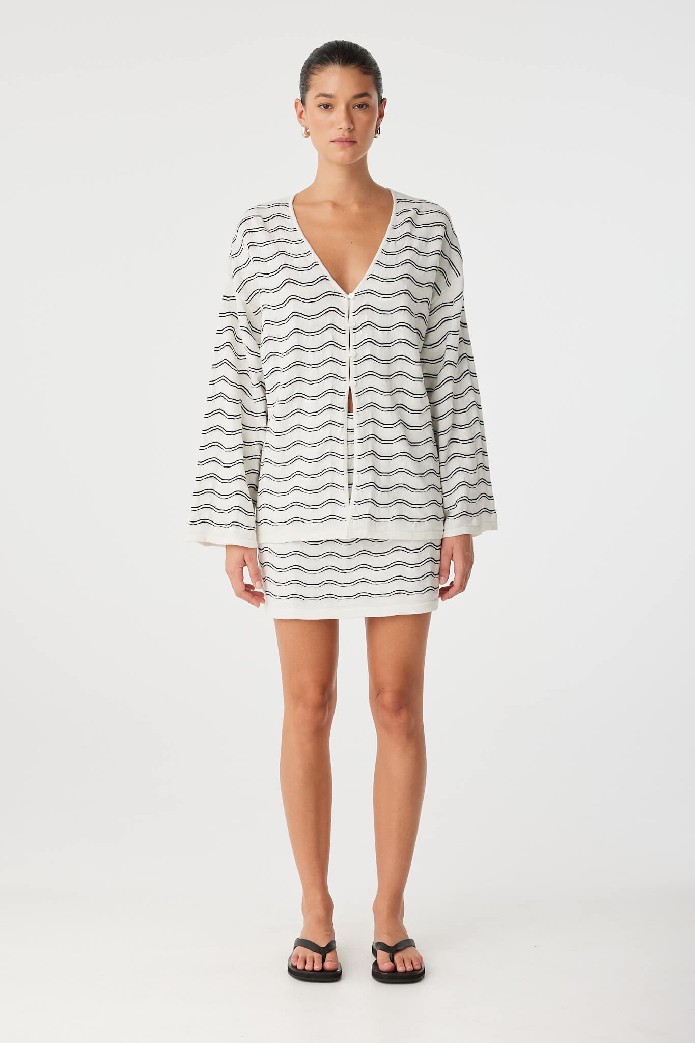 Onda Mini Skirt styled with matching wave knit top, worn as a coordinated set.