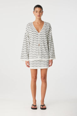 V-neck long sleeve top in wave knit, styled for warm-weather layering.