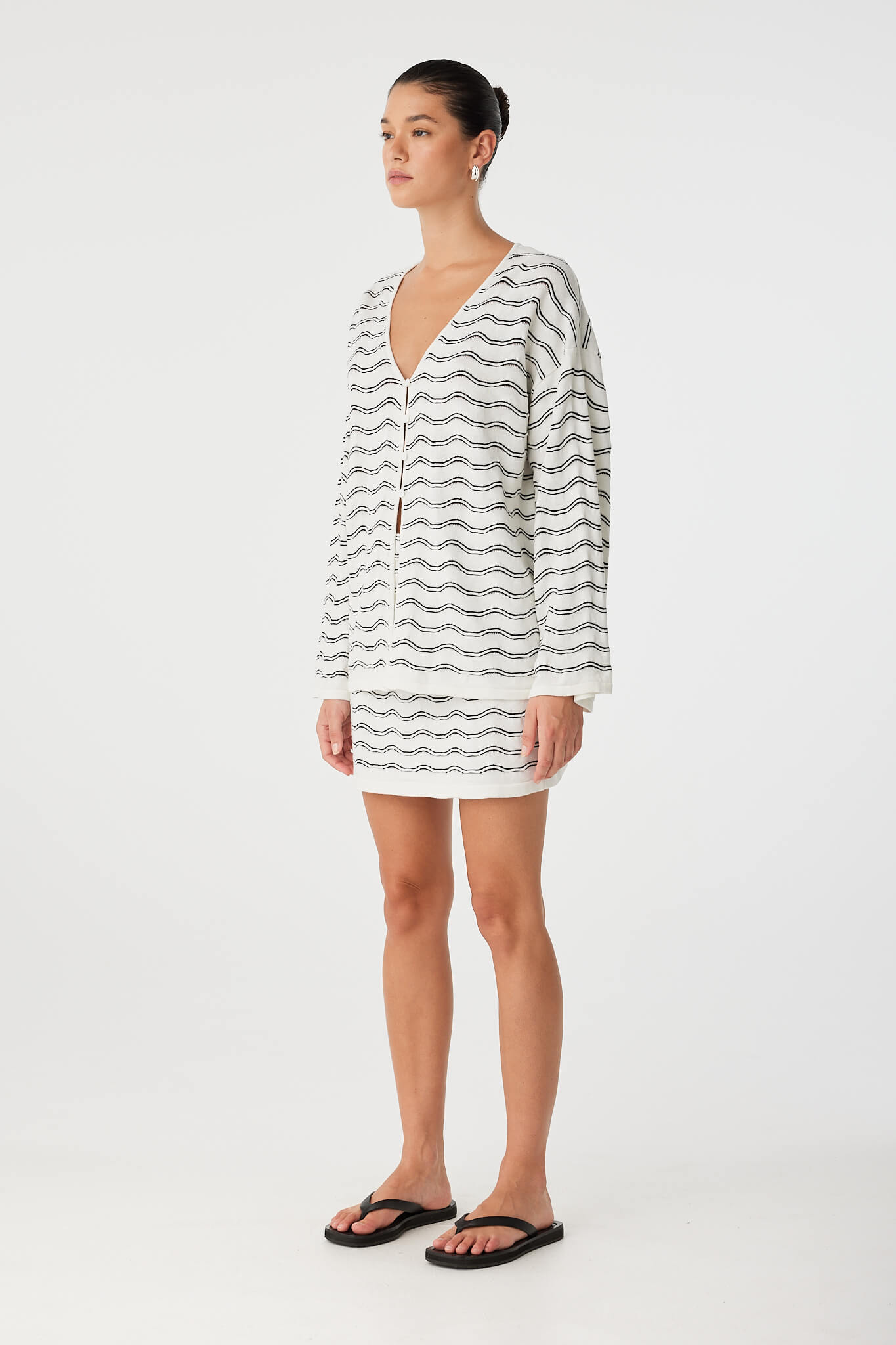 Side view of button-front wave top with natural sleeve volume and relaxed fit.