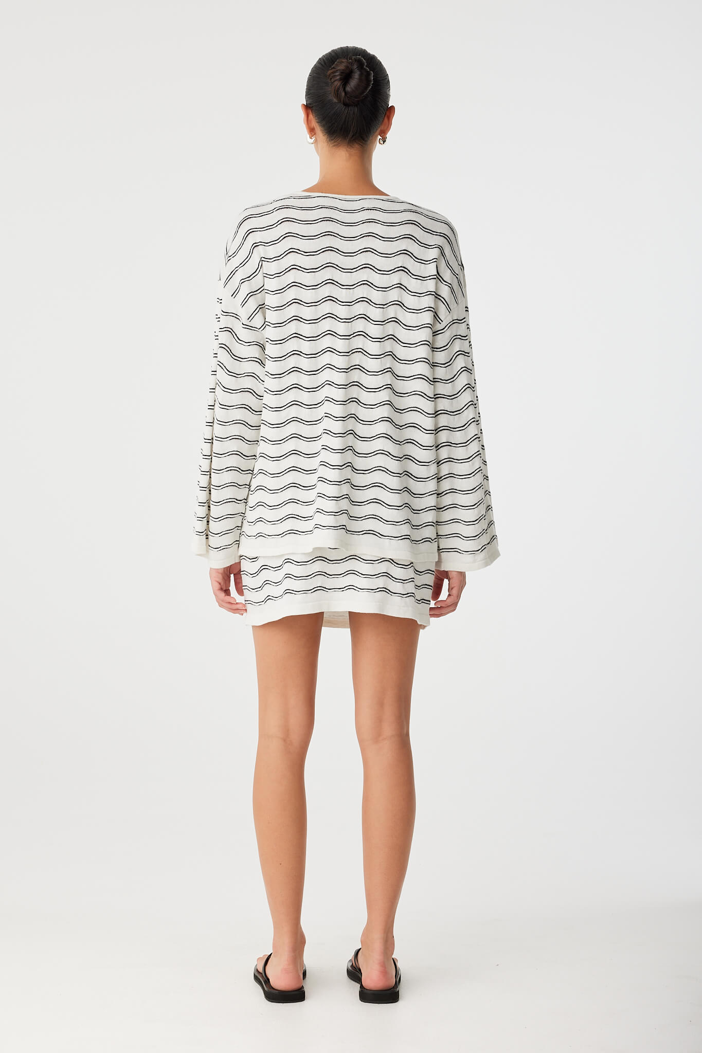 Back view of coordinated knit set in wave motif, showing straight silhouette.