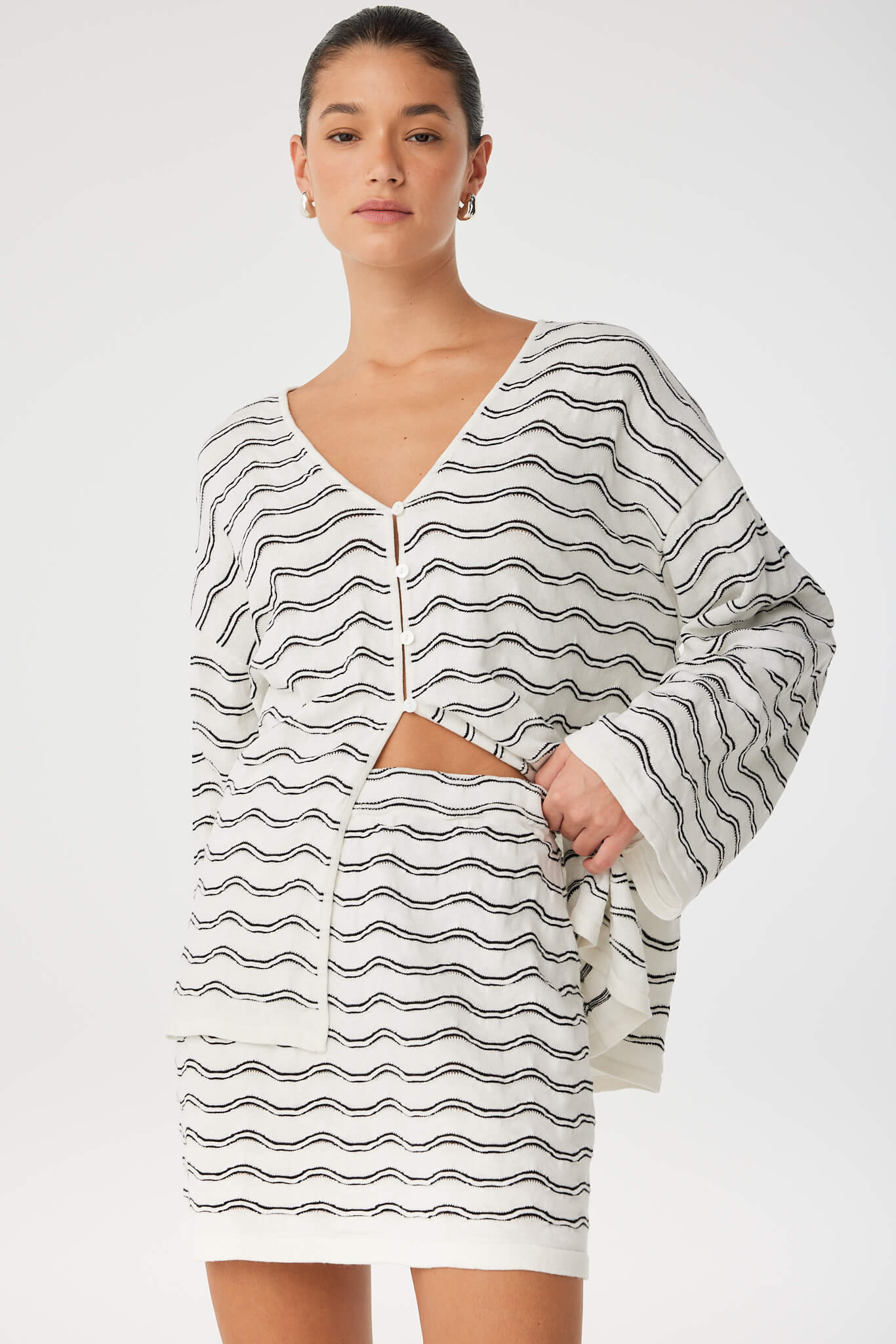 Onda Long Sleeve styled with matching mini skirt, showing relaxed drape and coordinated texture.