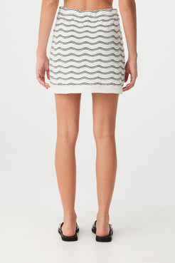 Back view of wave knit mini skirt with elastic waist and subtle texture.