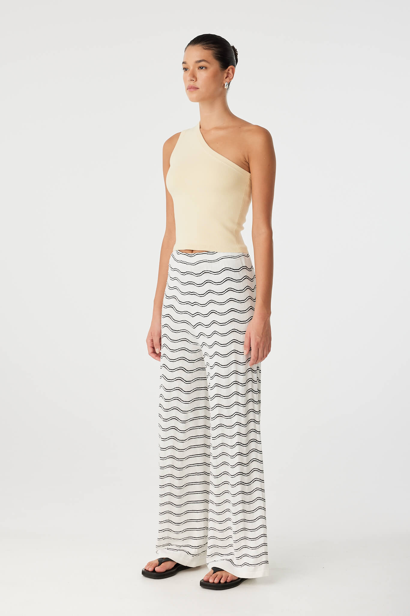 Side view of one-shoulder tank in butter organic cotton blend with soft stretch and clean line.