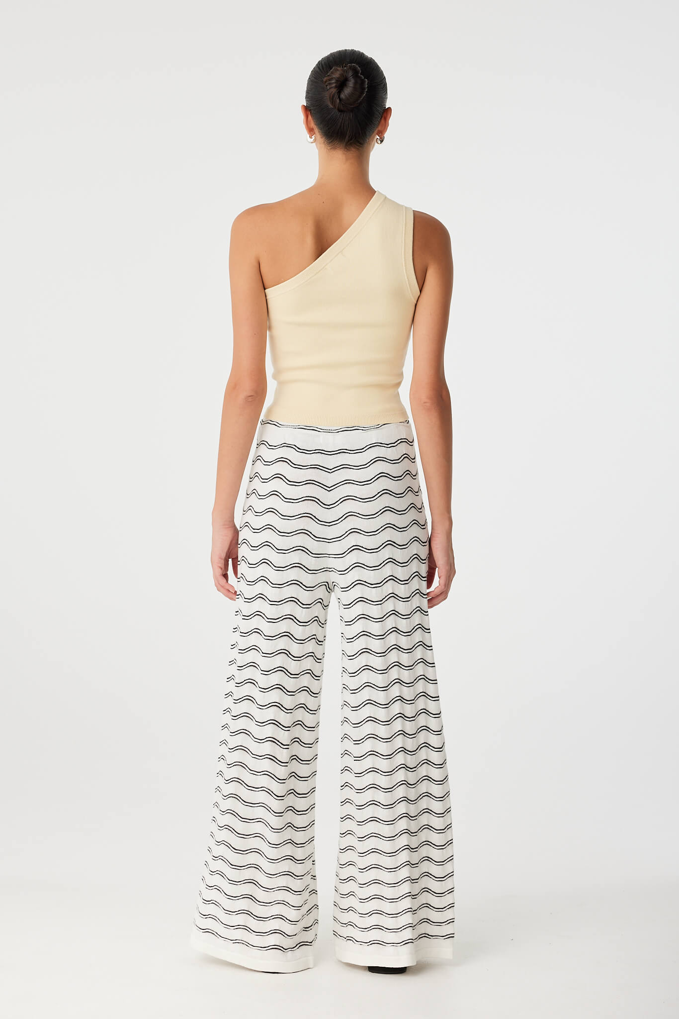 Back view of asymmetrical cropped tank with single strap and sculpted cotton knit.
