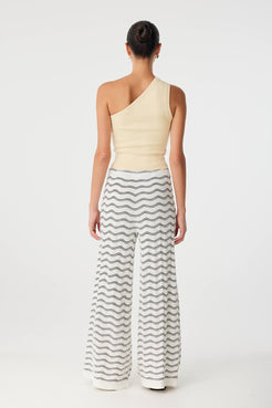 Back view of Onda Pant styled with fitted tank, revealing relaxed drape and clean knit texture.