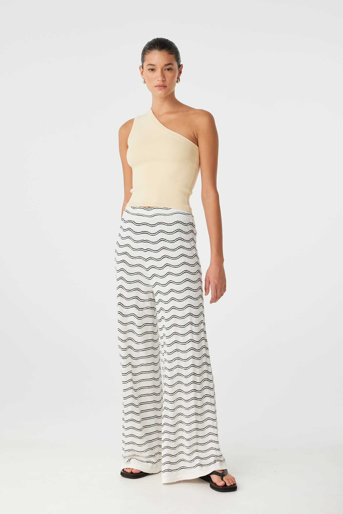 Full-body view of Isla Tank in butter yellow styled with printed wide-leg pants, showing sculpted fit and cropped silhouette in soft stretch knit.