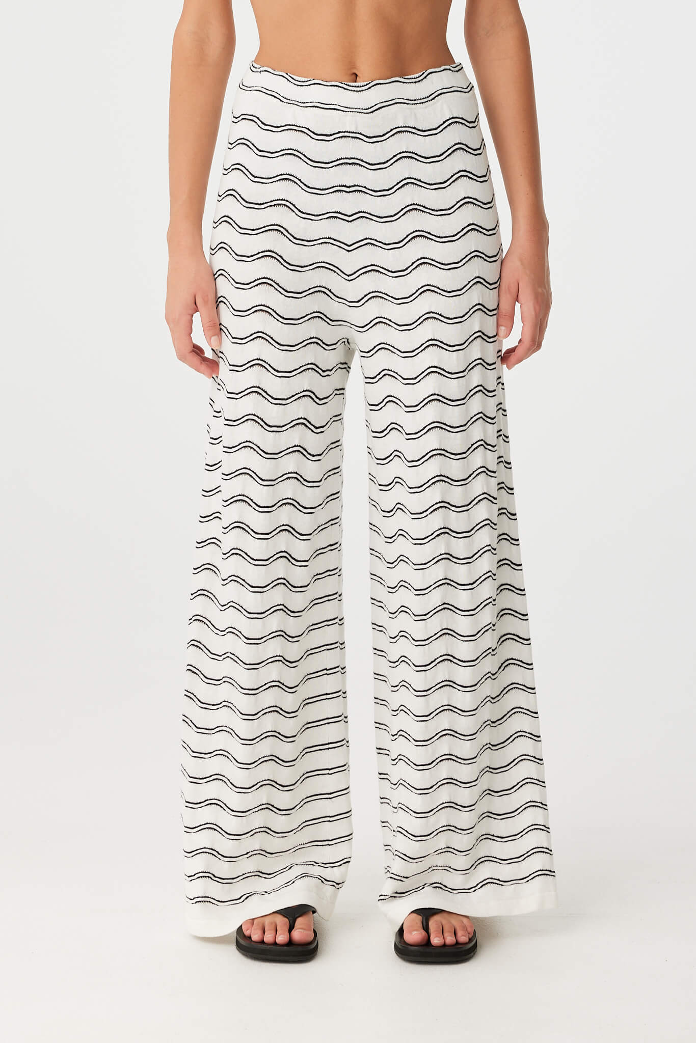 Front view of cream wave knit wide-leg pant with elastic waistband and flowing silhouette.