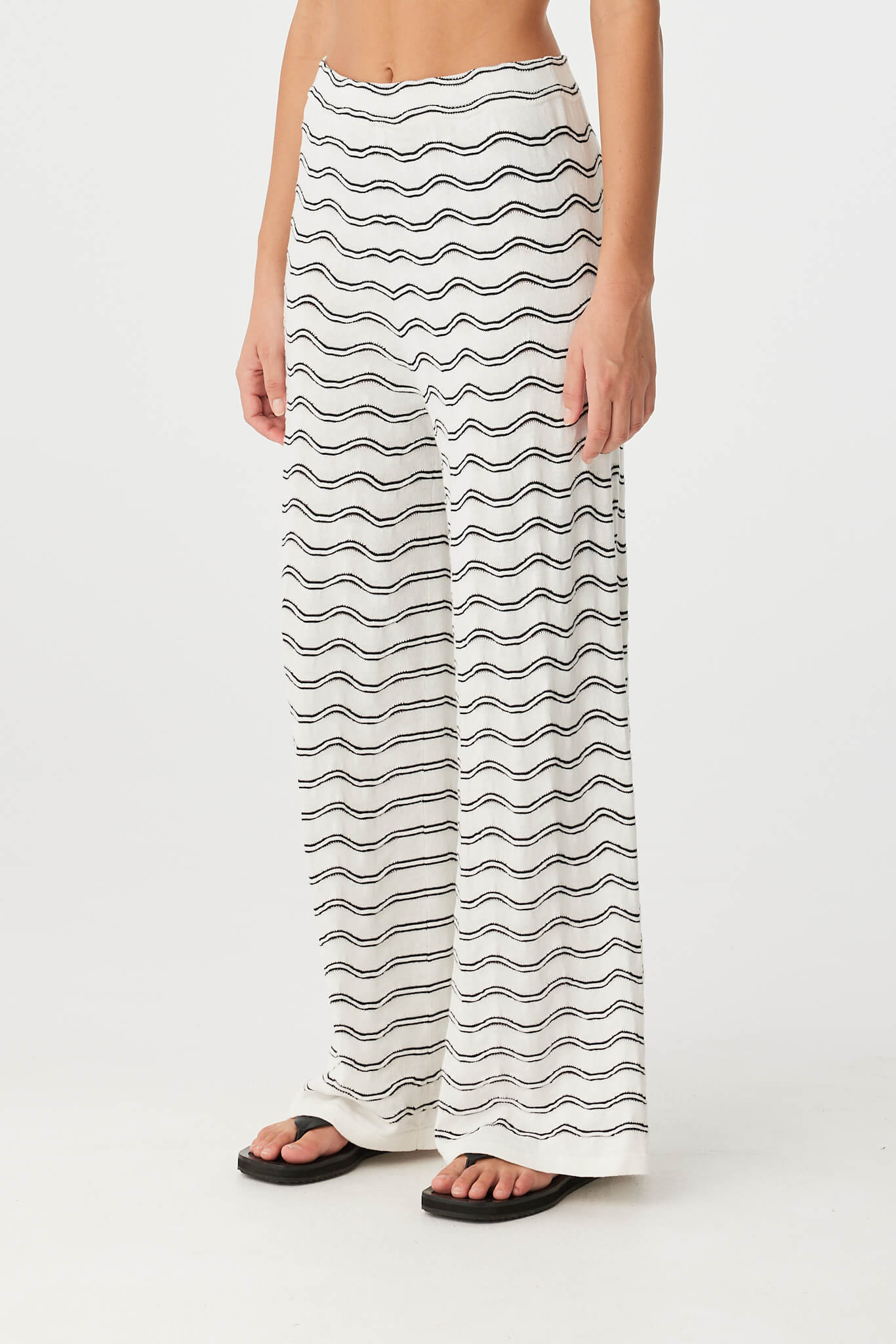 Side view of wave motif knit pant in linen blend, highlighting wide leg and waist detail.