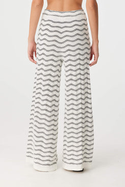 Back view of cream and black wave knit pants with elastic waistband and soft wide-leg cut.