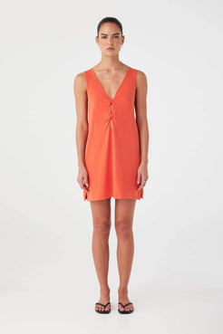 Model wearing mandarin linen–cotton mini dress with twist-front cutout detailing.