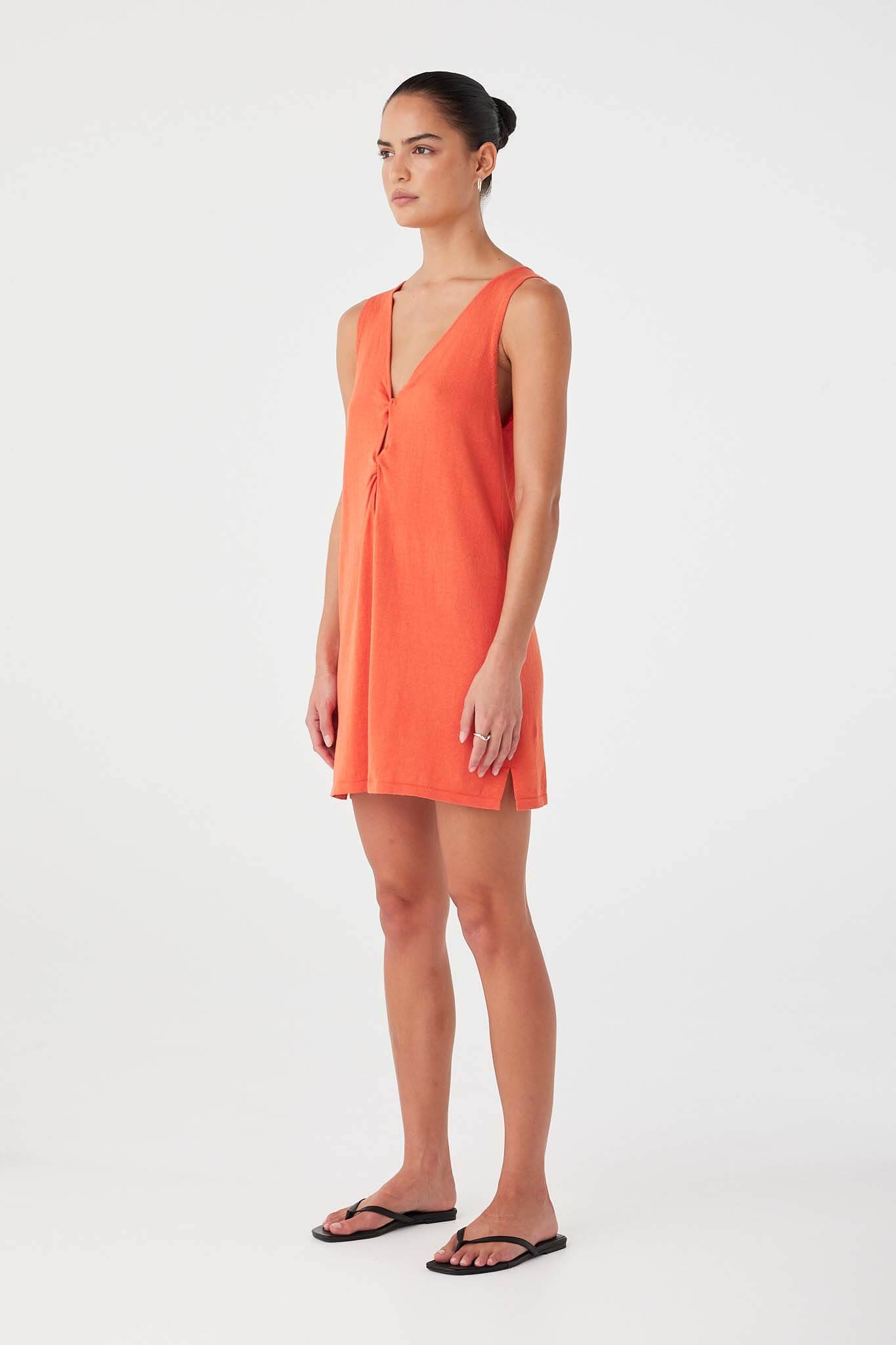 Side profile of mandarin mini dress in linen–cotton blend with lightweight drape.