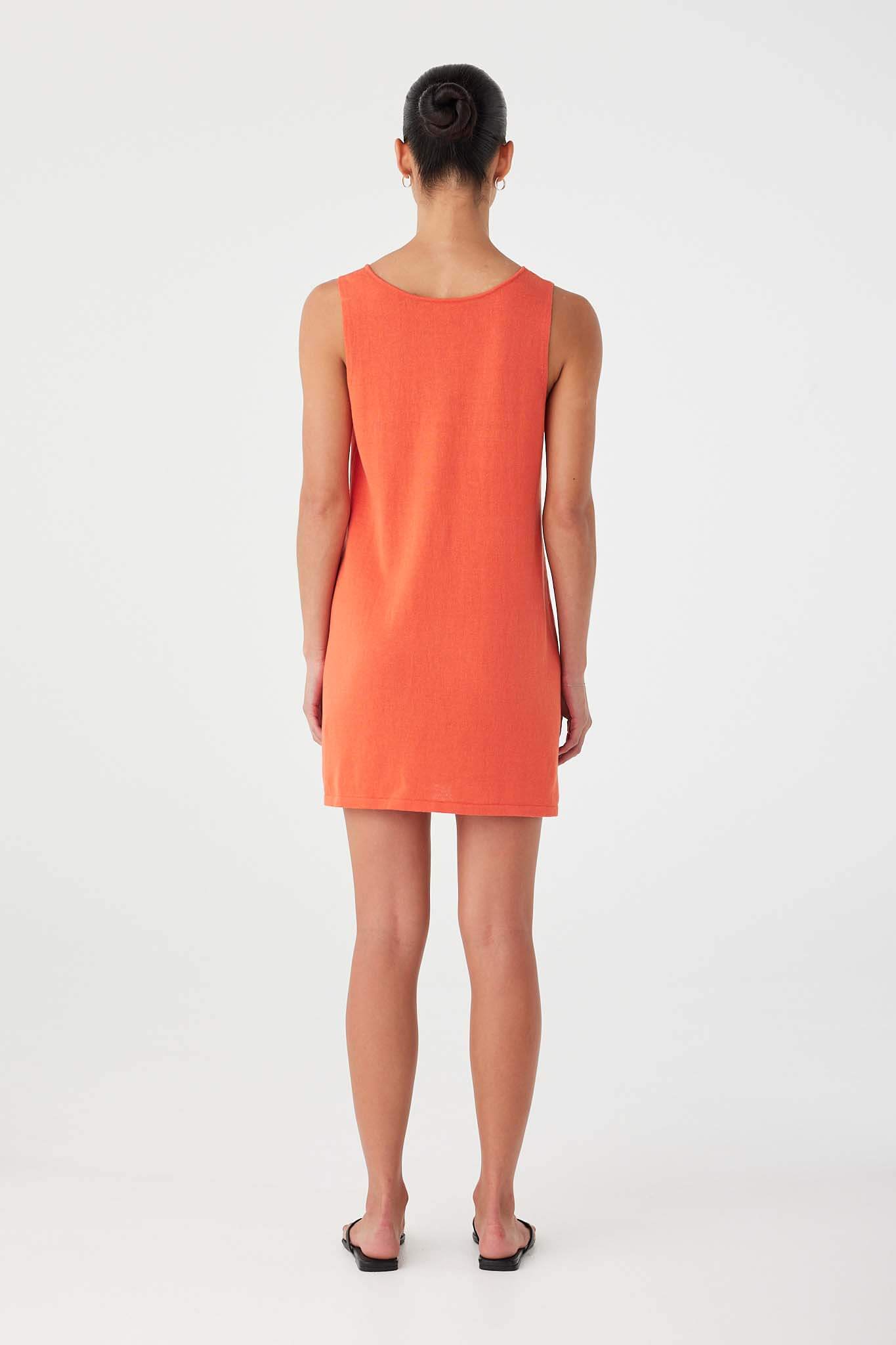 Back view of reversible orange (mandarin) mini dress in linen–cotton blend with simple scoop back.