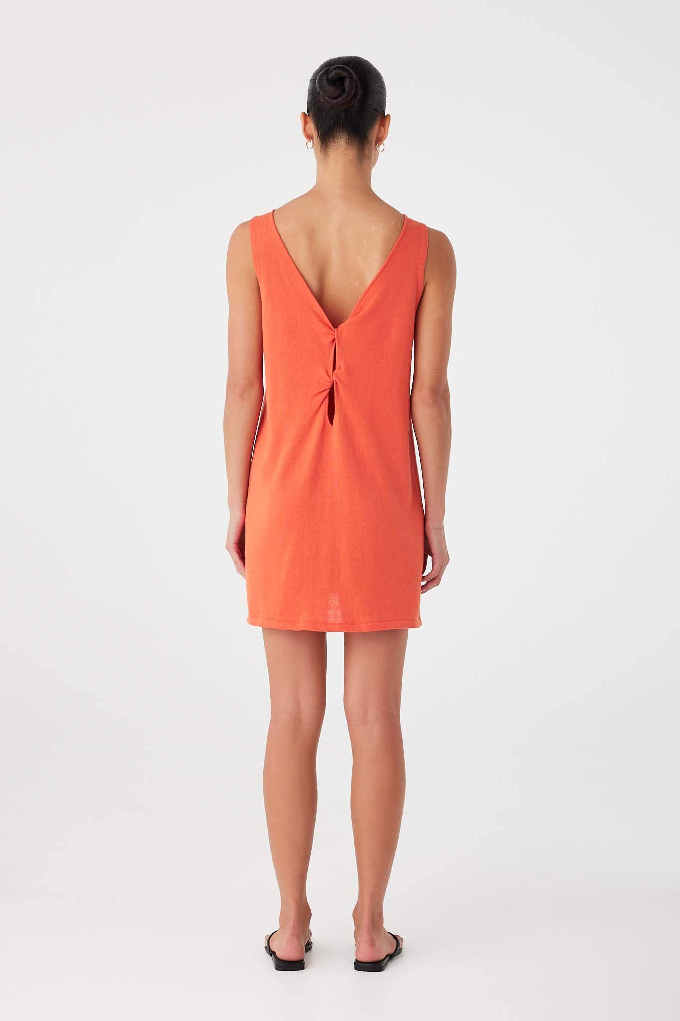 Back view of mandarin mini dress in linen–cotton blend showing twist-front cutout styling worn in reverse.