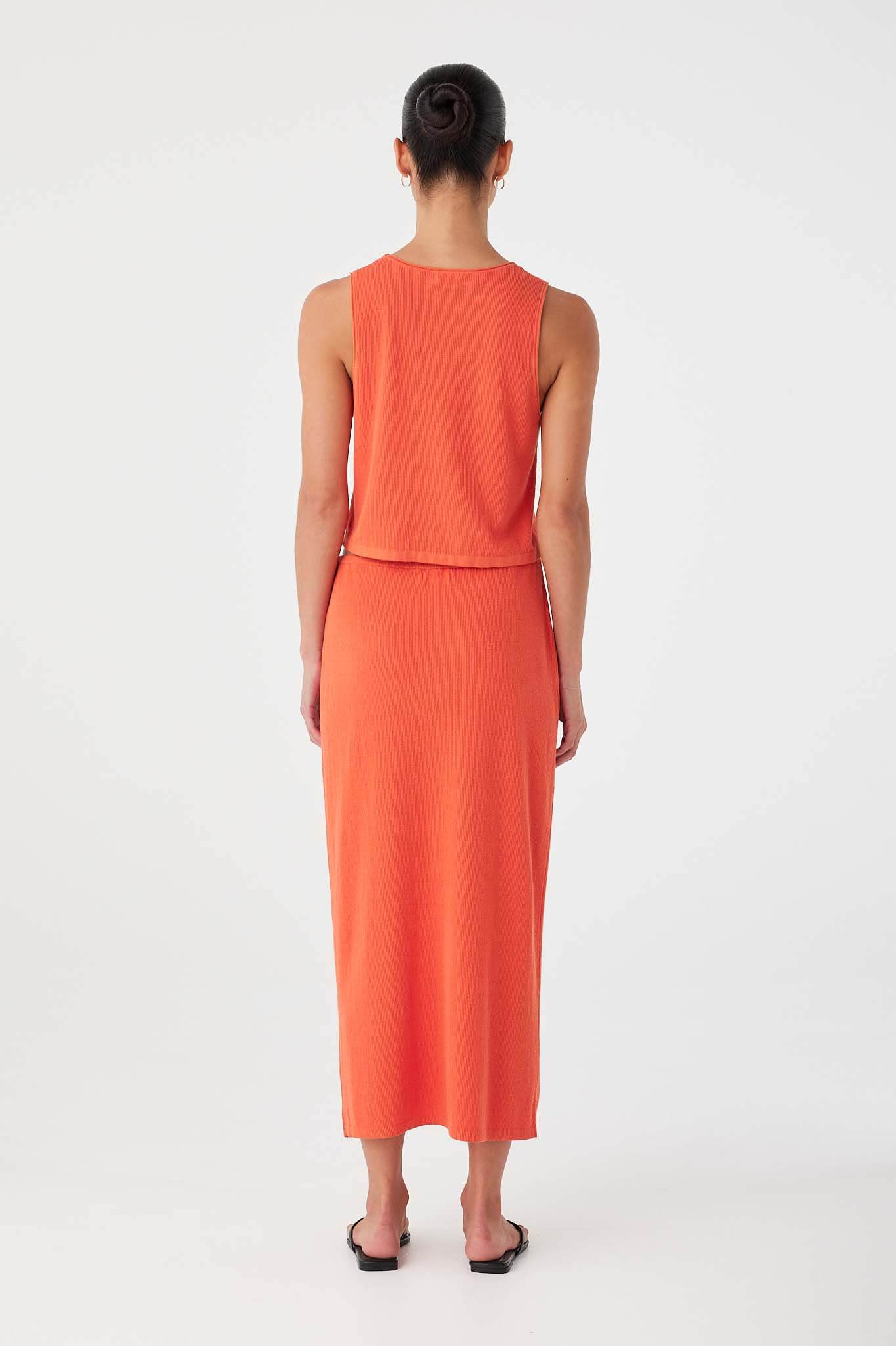 Orange (mandarin) longline rib knit skirt in organic cotton hemp blend with fluid movement.