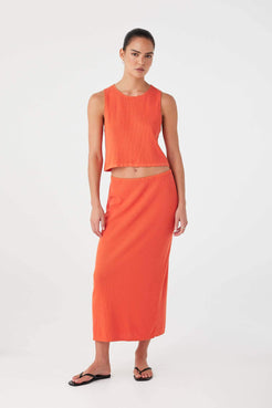 Model wearing mandarin knit tank top styled with tonal skirt, designed for warm-weather ease.