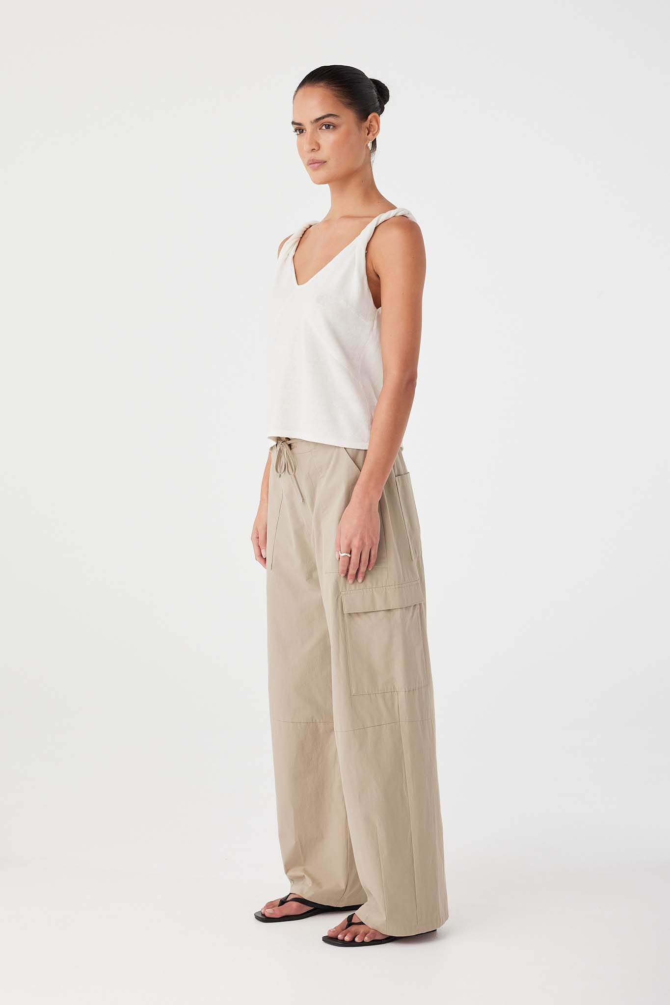 Relaxed-fit taupe cotton pants with elasticated waist and tie closure, designed for ease in everyday wear.