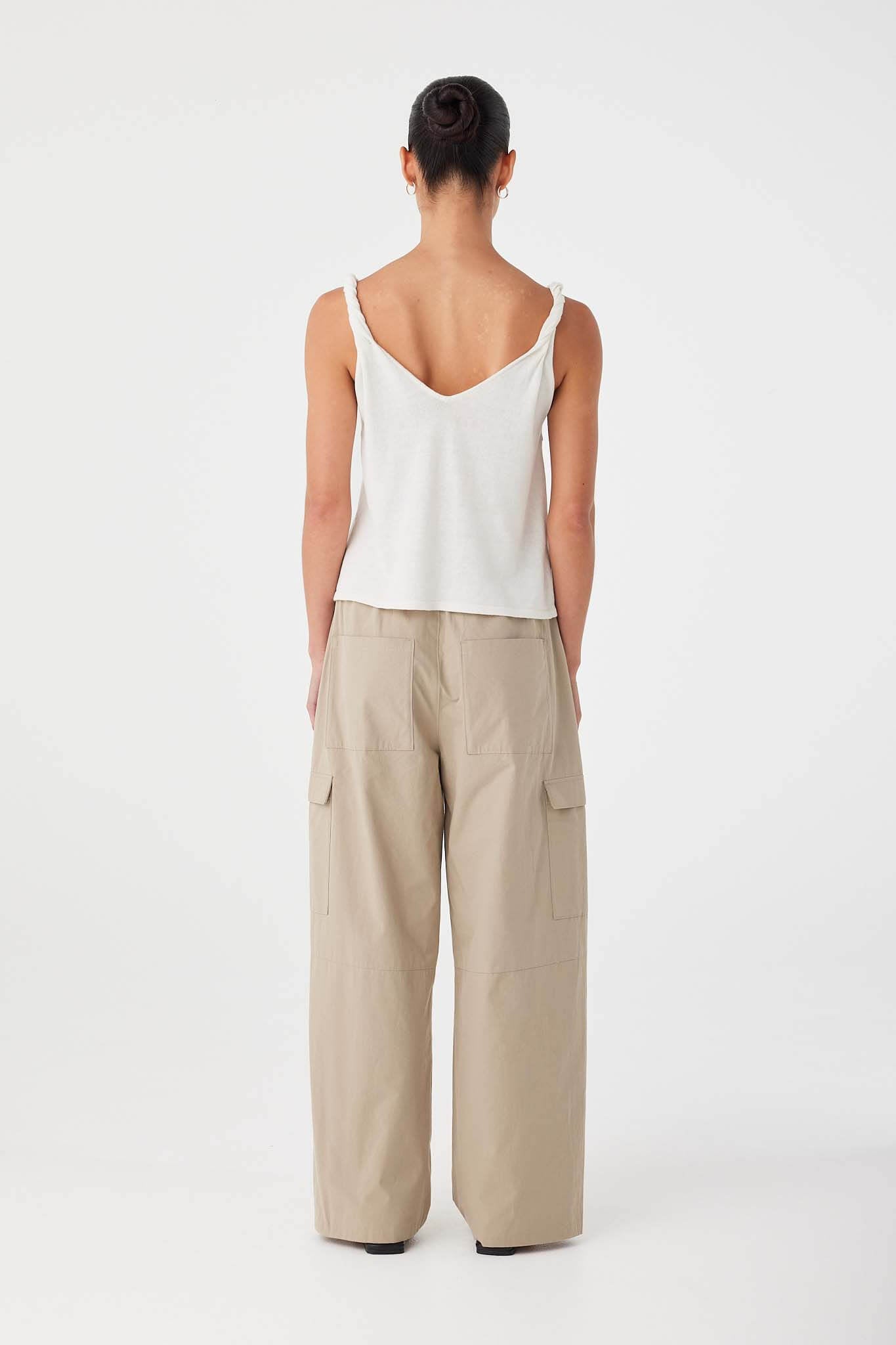 Back view of relaxed cream tank with twisted shoulder straps and straight hem, cut from breathable linen–cotton blend.