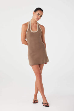 Model styling cacao knit mini dress with contrast rib neckline, designed for warm-weather wear.