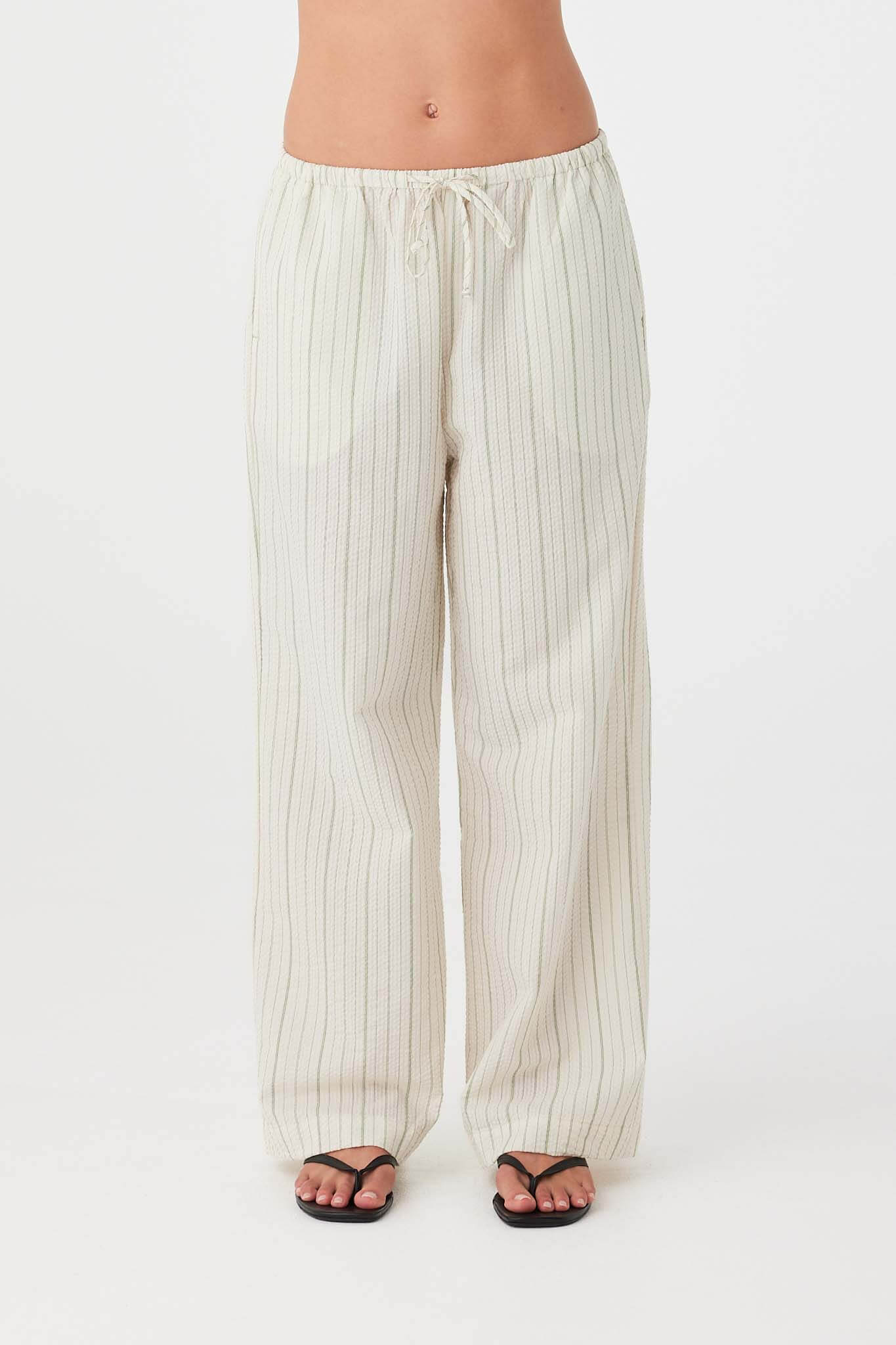 Textured cotton stripe pants in olive with elastic drawstring waistband and side pockets.