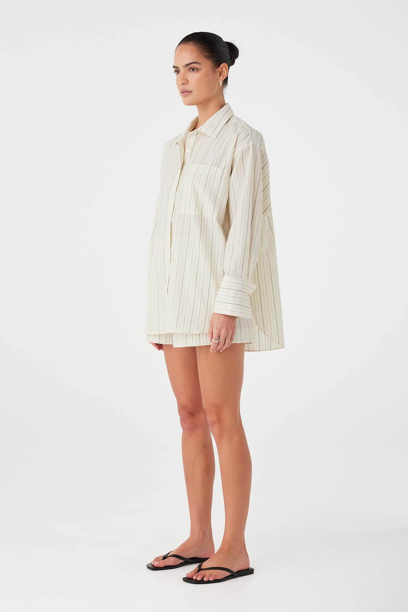 Olive stripe oversized cotton shirt styled in relaxed boyfriend fit with clean drape.