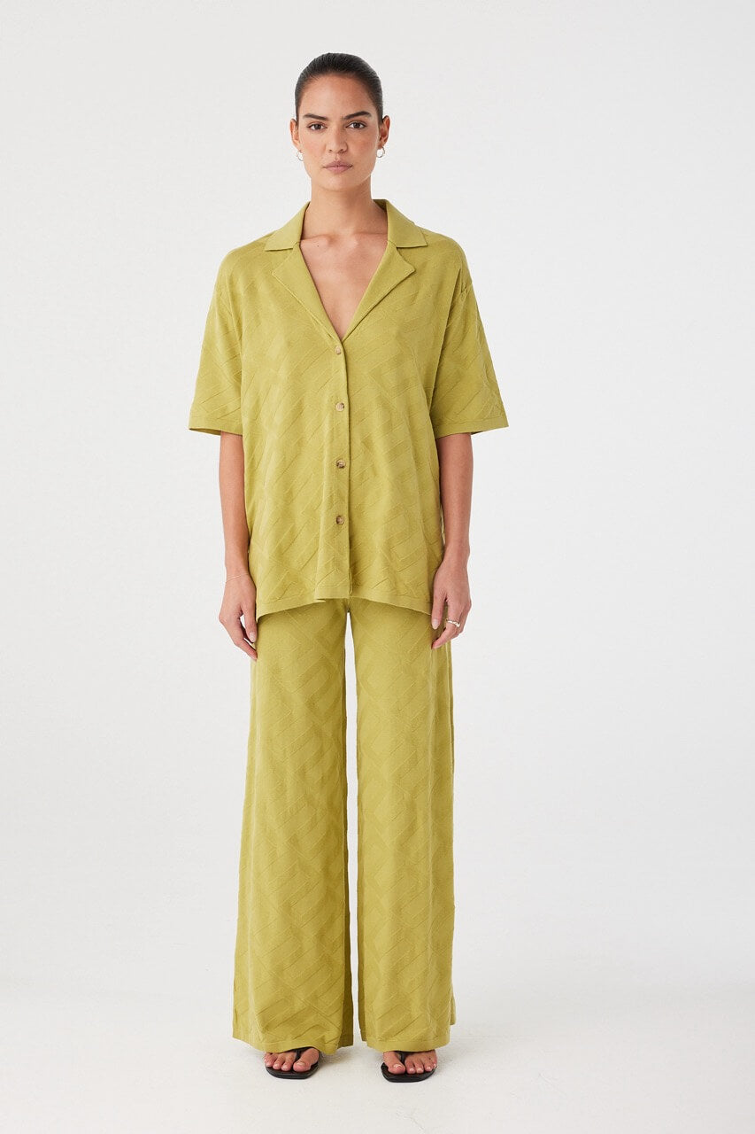 Lightweight matcha green shirt styled as a set with matching pants. Relaxed silhouette ideal for warm climates and layering.