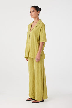 Side profile of matcha green pants showing relaxed fit and fluid movement. Designed for comfort in warm climates.