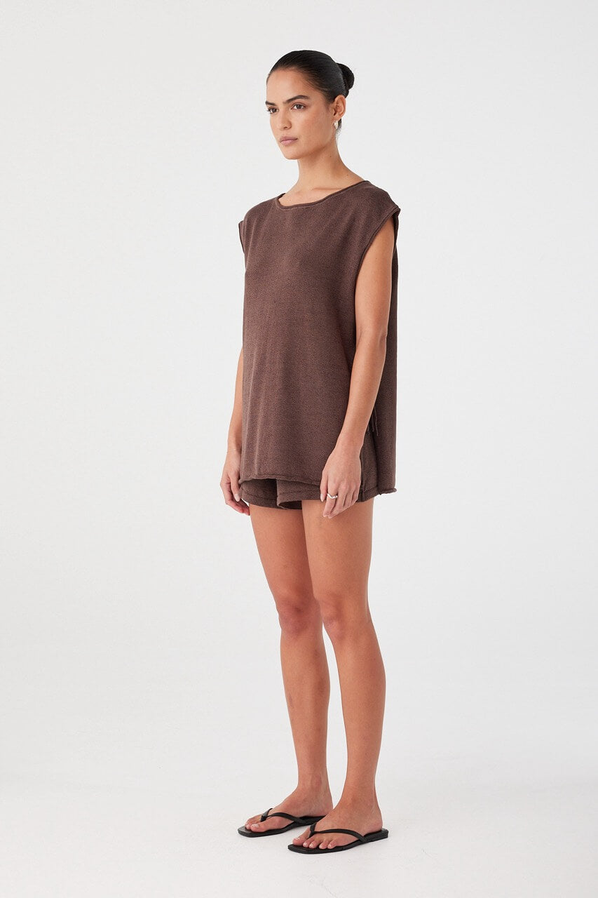 Side profile of espresso linen cotton shorts styled with matching top. Relaxed fit with natural drape and clean shape.