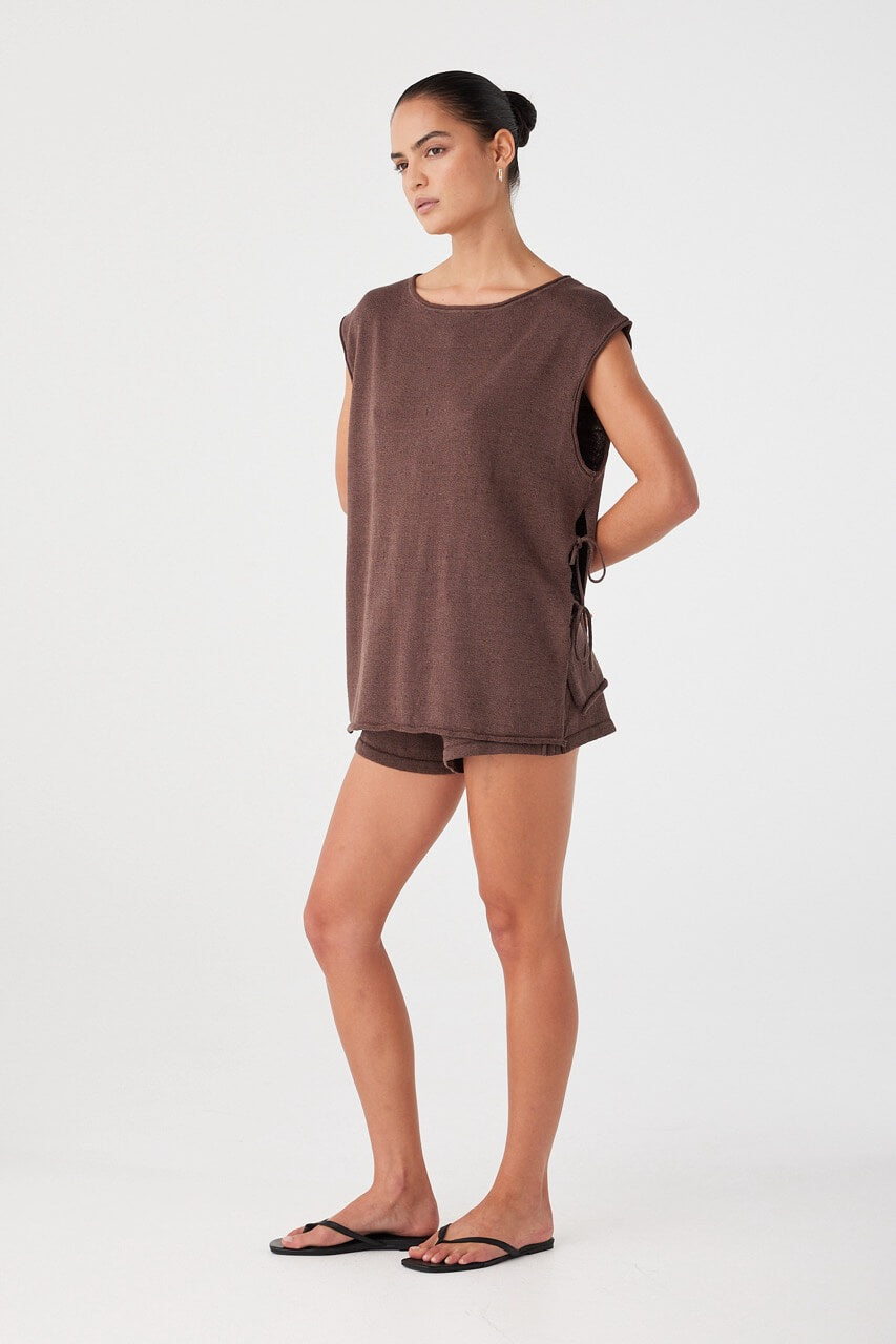 Model styled in espresso set with relaxed shorts and oversized top. Drawcord waist and minimal detailing for off-duty dressing.