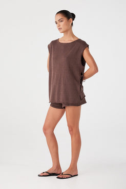 Model styled in espresso set with relaxed shorts and oversized top. Drawcord waist and minimal detailing for off-duty dressing.